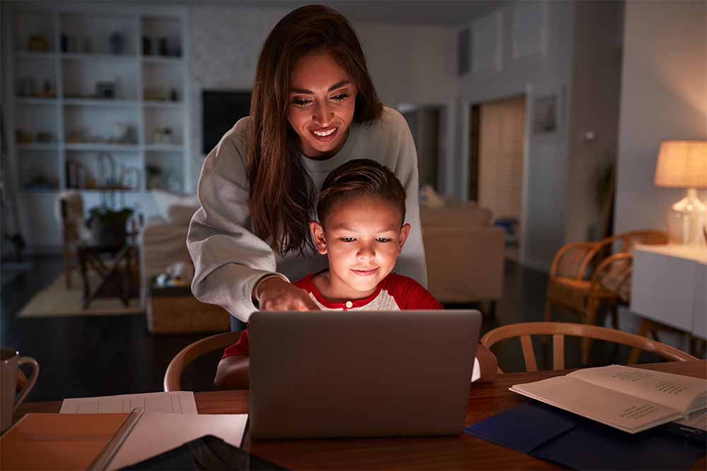 mother helping boy with homework engage student portal